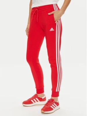 Zdjęcie produktu adidas Spodnie dresowe Essentials 3-Stripes IY1719 Czerwony Slim Fit