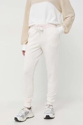 Zdjęcie produktu Armani Exchange spodnie dresowe kolor beżowy z nadrukiem
