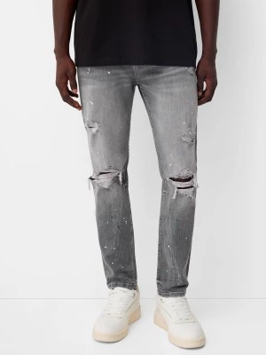 Zdjęcie produktu Bershka Jeansy Skinny Z Przetarciami I Plamami Farby Mężczyzna Szary