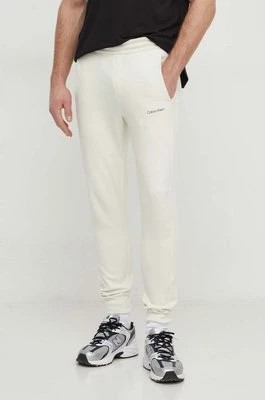 Zdjęcie produktu Calvin Klein spodnie dresowe kolor beżowy gładkie