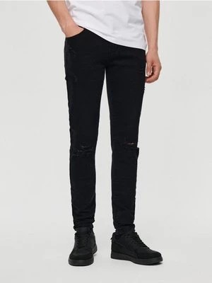 Zdjęcie produktu Czarne jeansy slim fit z przetarciami House