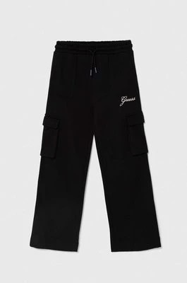 Zdjęcie produktu Guess spodnie dresowe bawełniane dziecięce kolor czarny gładkie J4YQ13 KA6R3