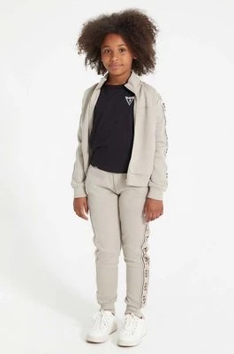 Zdjęcie produktu Guess spodnie dresowe dziecięce kolor beżowy wzorzyste