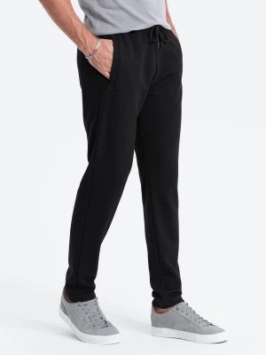 Zdjęcie produktu Męskie spodnie dresowe o marchewkowym kroju - czarne V1 OM-PASK-0166
 -                                    M