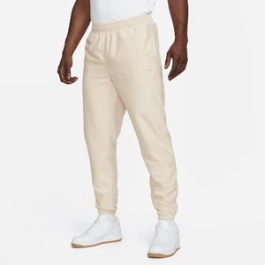 Zdjęcie produktu Męskie spodnie z tkaniny Nike Sportswear - Brązowy