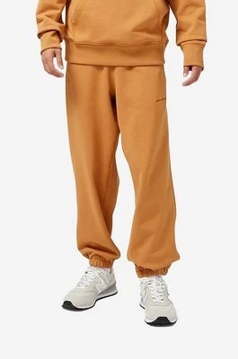 Zdjęcie produktu New Balance spodnie dresowe bawełniane kolor pomarańczowy gładkie (puste)