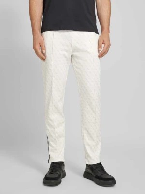 Zdjęcie produktu Spodnie dresowe z nadrukiem z logo na całej powierzchni model ‘KORBIN’ Guess Activewear