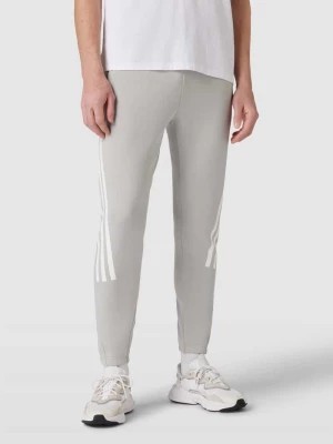 Zdjęcie produktu Spodnie dresowe z paskami w kontrastowym kolorze ADIDAS SPORTSWEAR